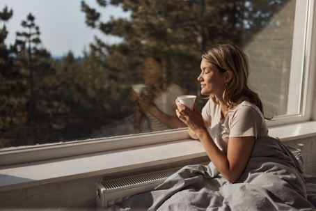 woman enjoying in morning coffee and sun
